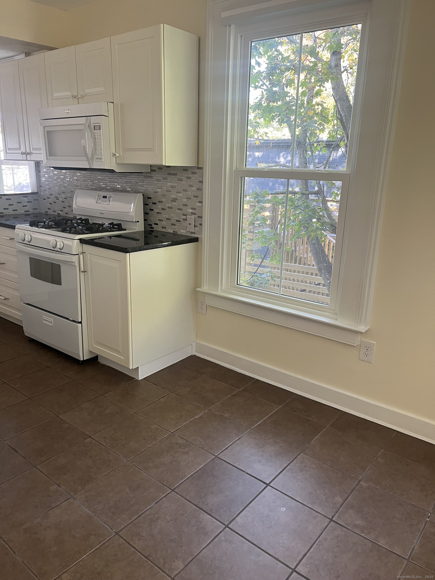 896 Quinnipiac Avenue, Unit 3 New Haven, CT 06513 - Photo 6 of 38 a kitchen with a white cabinets and a stove top oven