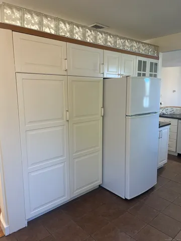 a refrigerator freezer sitting in a kitchen