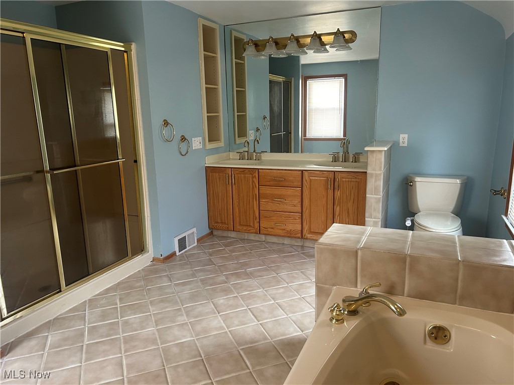 1194 Croyden Road Lyndhurst, OH 44124 - Photo 22 of 25 Full bathroom featuring double vanity, light tile patterned floors, a shower stall, and a tub with jets