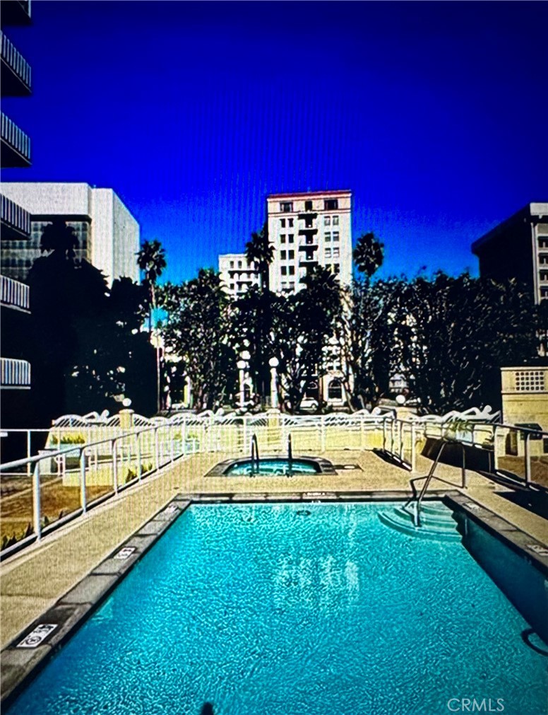 488 East Ocean Boulevard, Unit 1706 Long Beach, CA 90802 - Photo 13 of 14 a view of a swimming pool with a bench and trees in the background