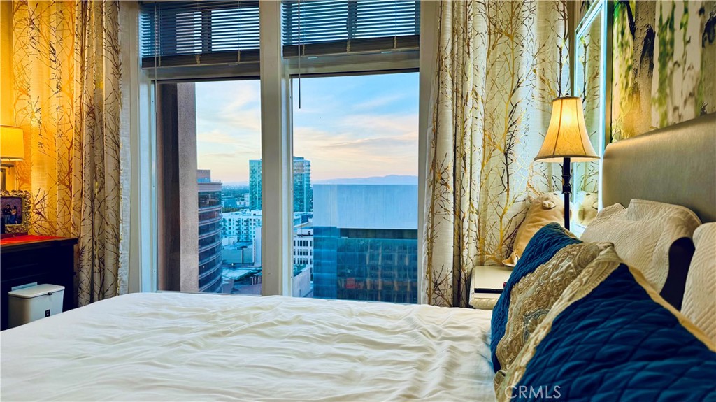 488 East Ocean Boulevard, Unit 1706 Long Beach, CA 90802 - Photo 5 of 14 a bedroom with a bed and wooden floor