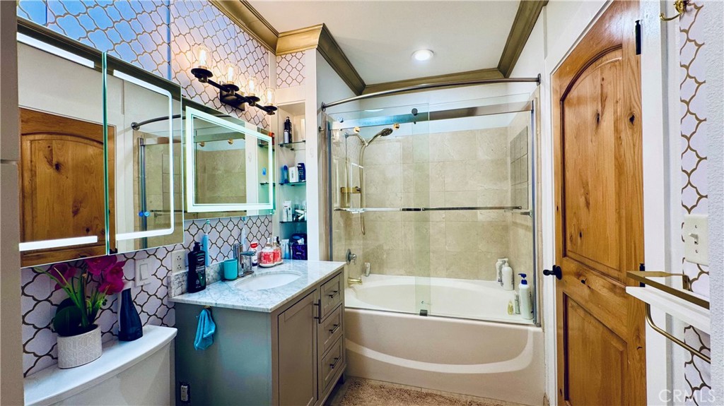 488 East Ocean Boulevard, Unit 1706 Long Beach, CA 90802 - Photo 8 of 14 a bathroom with a granite countertop sink mirror vanity and bathtub