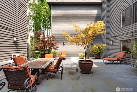 a view of a patio with table and chairs