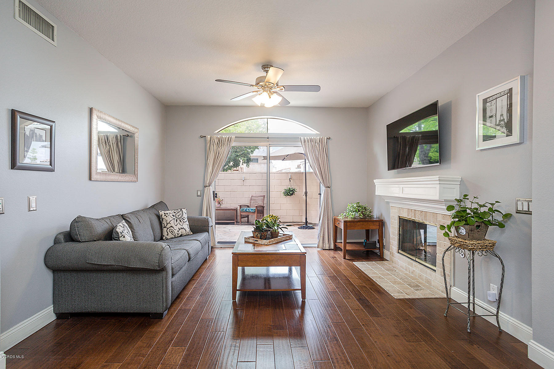 4251 Rusticview Court Moorpark, CA 93021 - Photo 1 of 27 a living room with furniture a fireplace and a flat screen tv