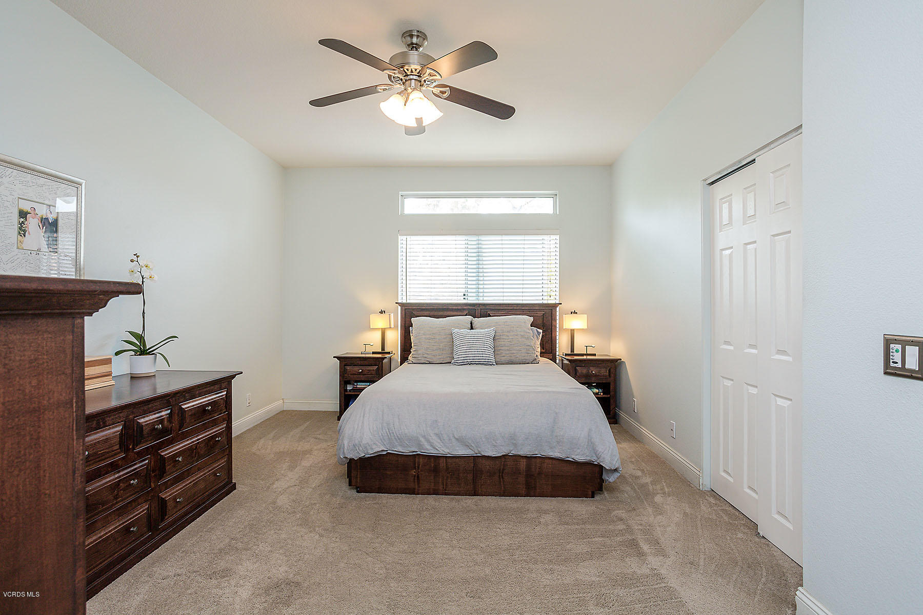 4251 Rusticview Court Moorpark, CA 93021 - Photo 12 of 27 a spacious bedroom with a bed and a chandelier