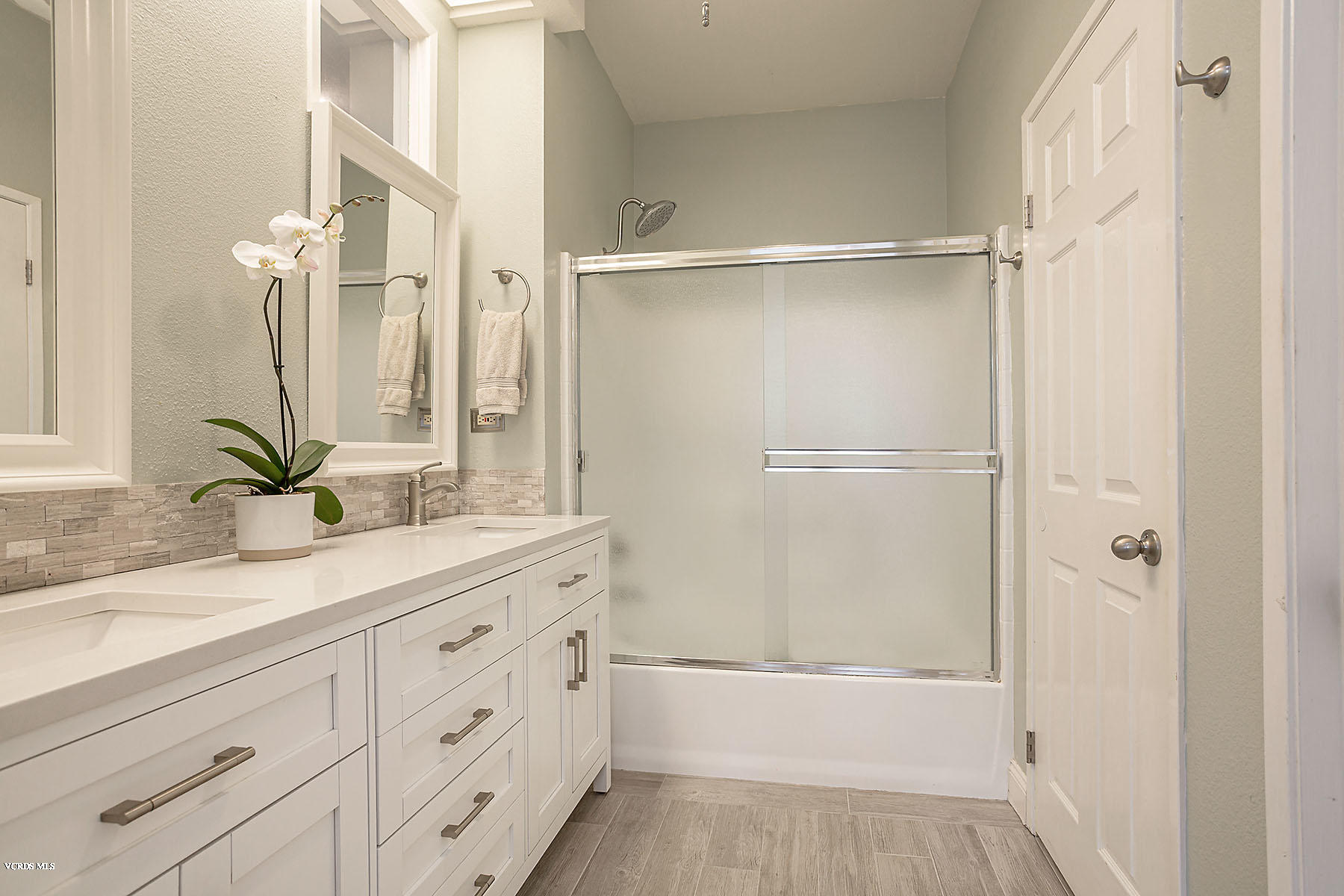 4251 Rusticview Court Moorpark, CA 93021 - Photo 14 of 27 a bathroom with a granite countertop sink a mirror and a bathtub