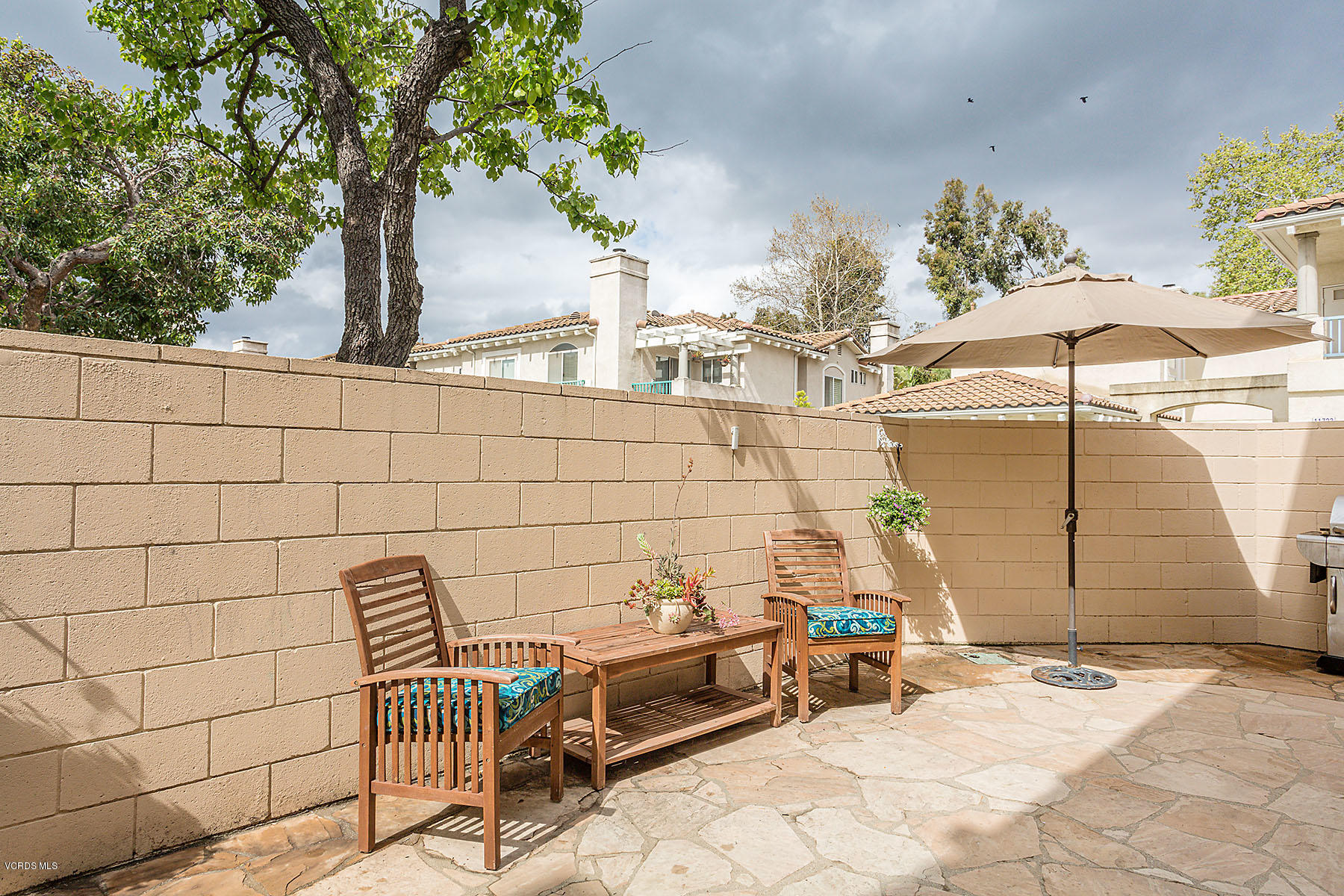 4251 Rusticview Court Moorpark, CA 93021 - Photo 18 of 27 a backyard of a house with barbeque oven table and chairs