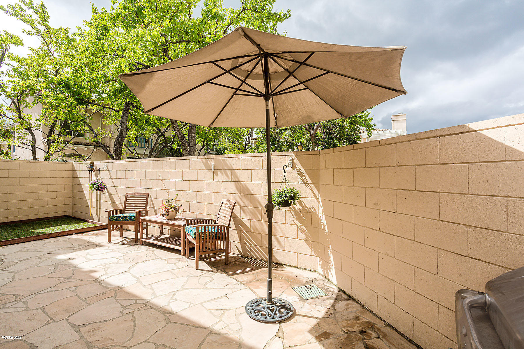 4251 Rusticview Court Moorpark, CA 93021 - Photo 19 of 27 a patio with a patio table and chairs