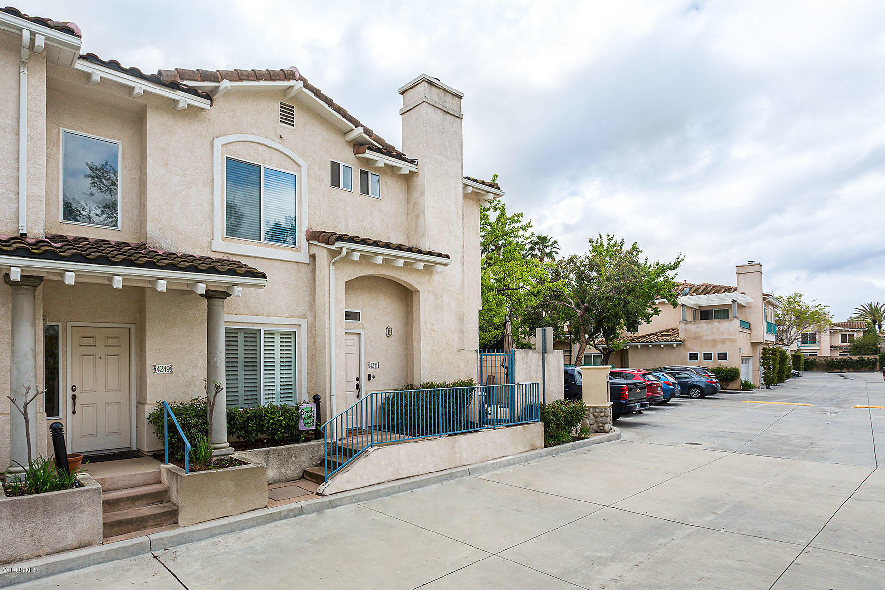 4251 Rusticview Court Moorpark, CA 93021 - Photo 27 of 27 a view of a white house with a large windows and a small yard