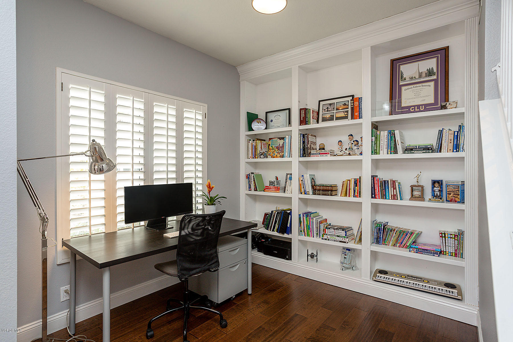 4251 Rusticview Court Moorpark, CA 93021 - Photo 10 of 27 a view of a workspace with a bookshelf