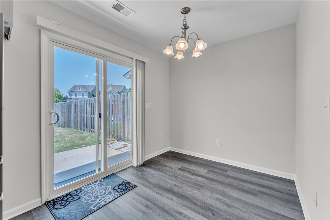 208 Samuel Street Pendleton, SC 29670 - Photo 24 of 32 Sliding glass doors open to a fenced yard, filling this dining area with abundant light.