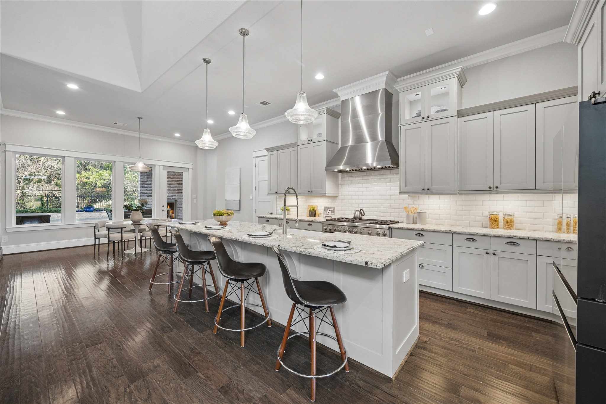 2223 Blue Duck Lane Conroe, TX 77384 - Photo 13 of 38 a kitchen with stainless steel appliances granite countertop a stove a refrigerator a kitchen island a sink and white cabinets with wooden floor