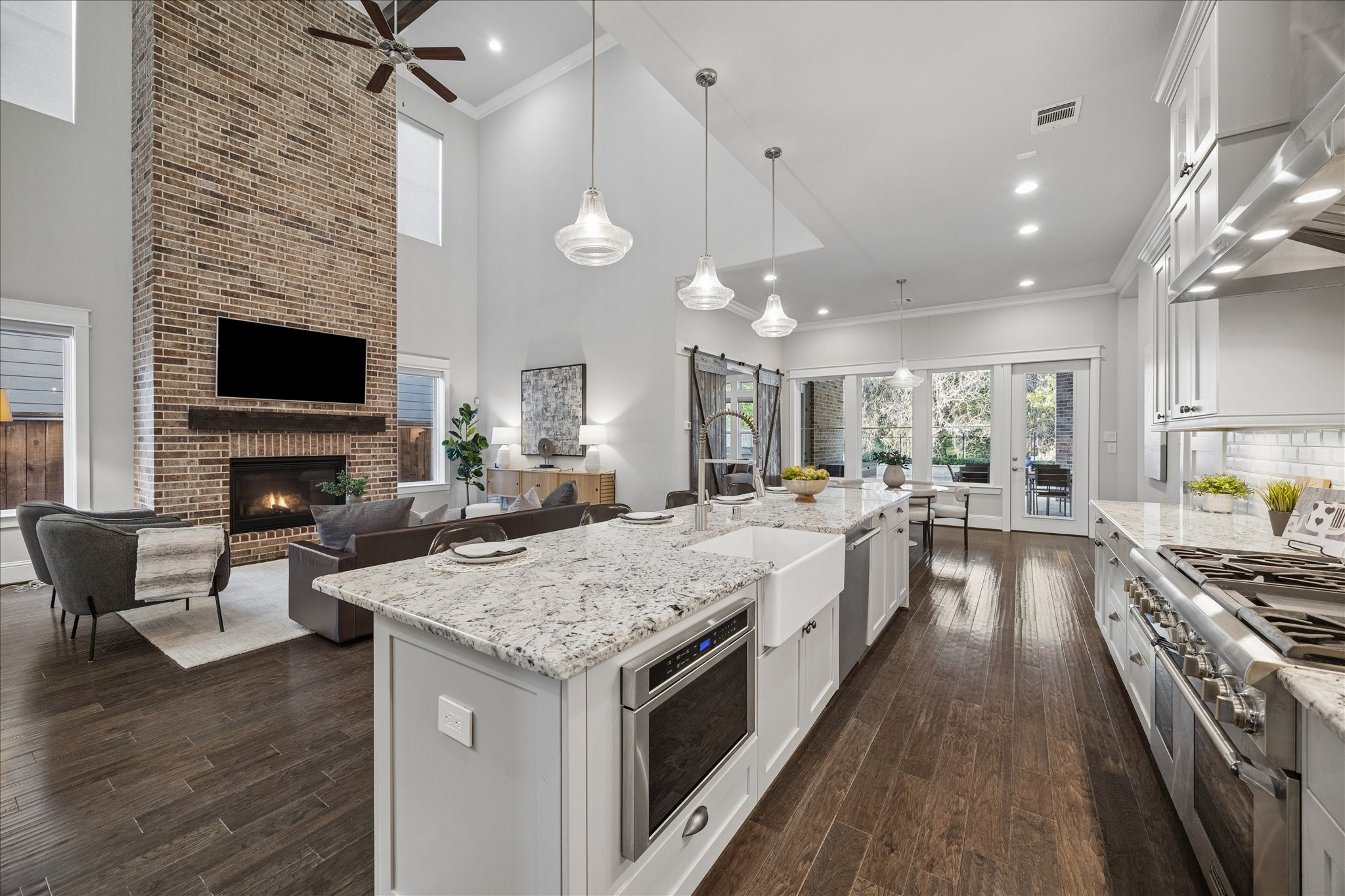 2223 Blue Duck Lane Conroe, TX 77384 - Photo 14 of 38 a large kitchen with kitchen island a large island in the center