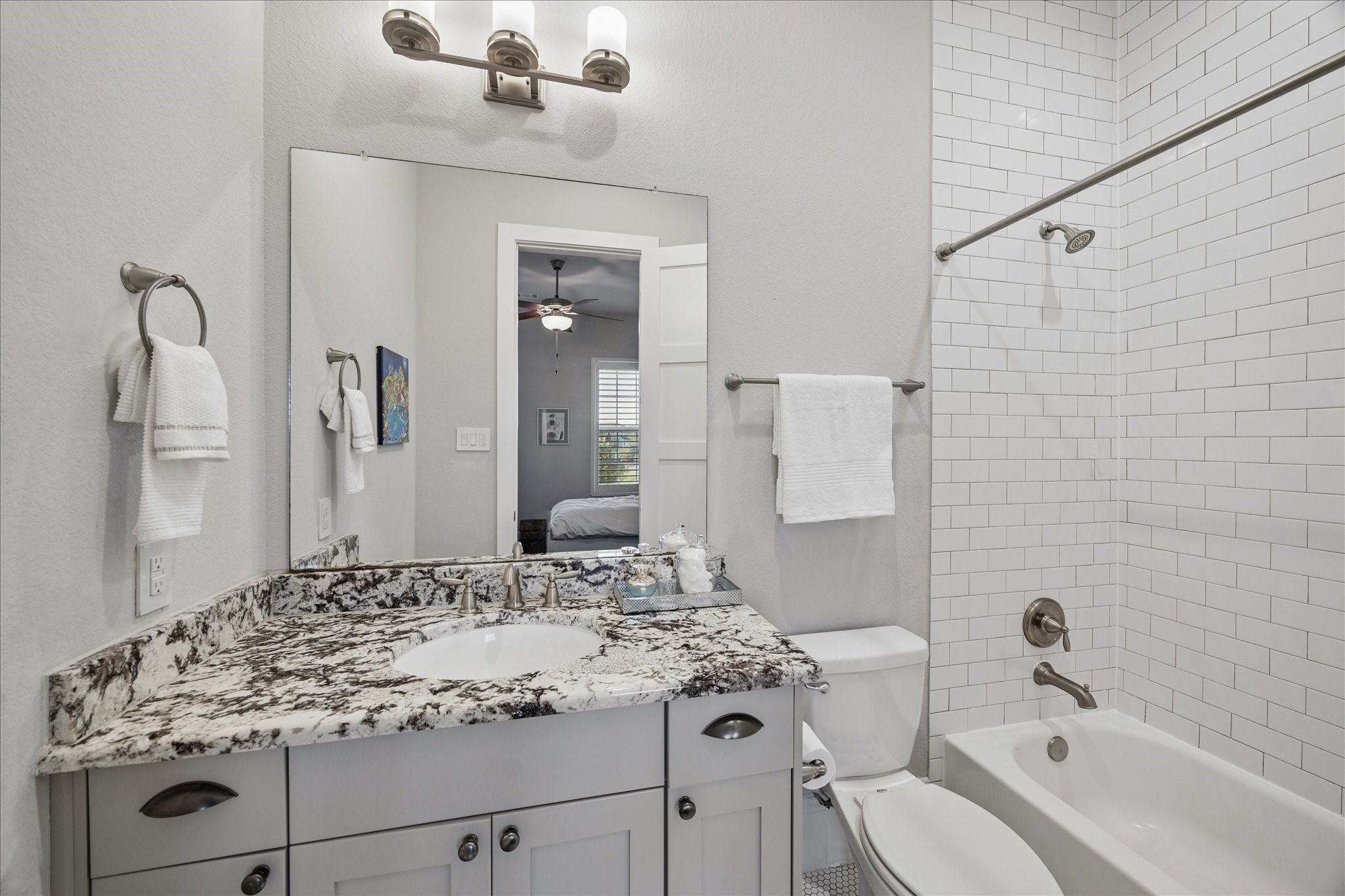 2223 Blue Duck Lane Conroe, TX 77384 - Photo 28 of 38 a bathroom with a sink and mirror with bathtub