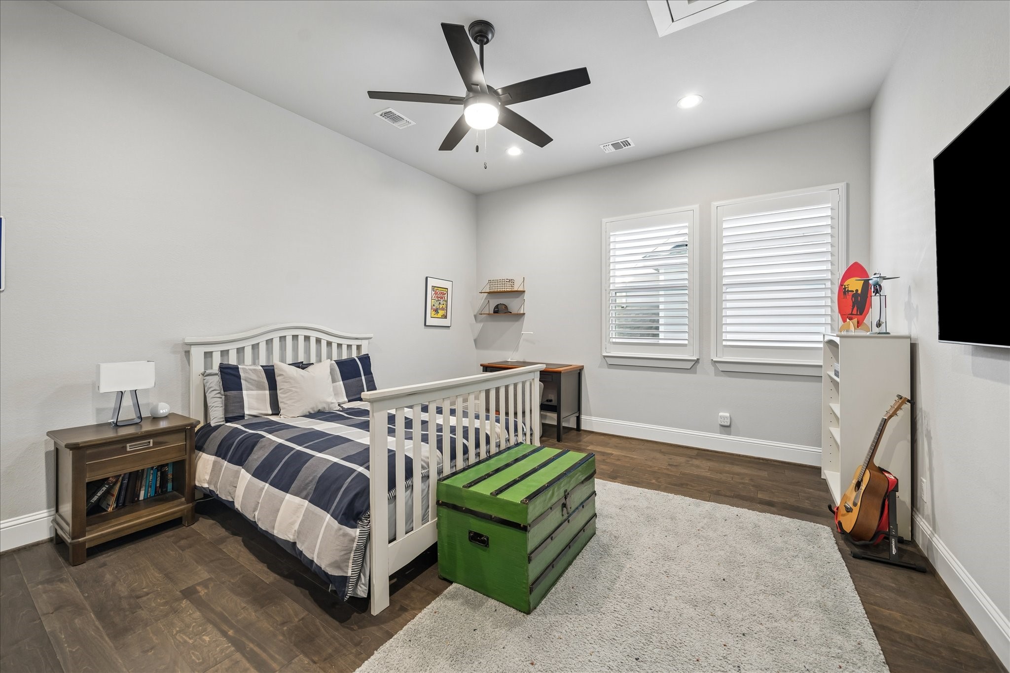 2223 Blue Duck Lane Conroe, TX 77384 - Photo 30 of 38 a bedroom with a bed a couch and a flat tv screen