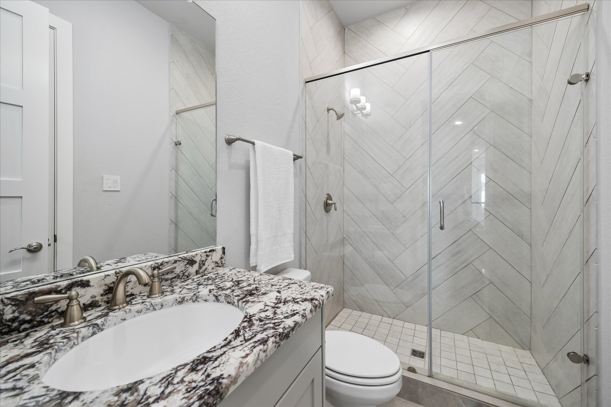 2223 Blue Duck Lane Conroe, TX 77384 - Photo 31 of 38 a bathroom with a granite countertop sink toilet and shower