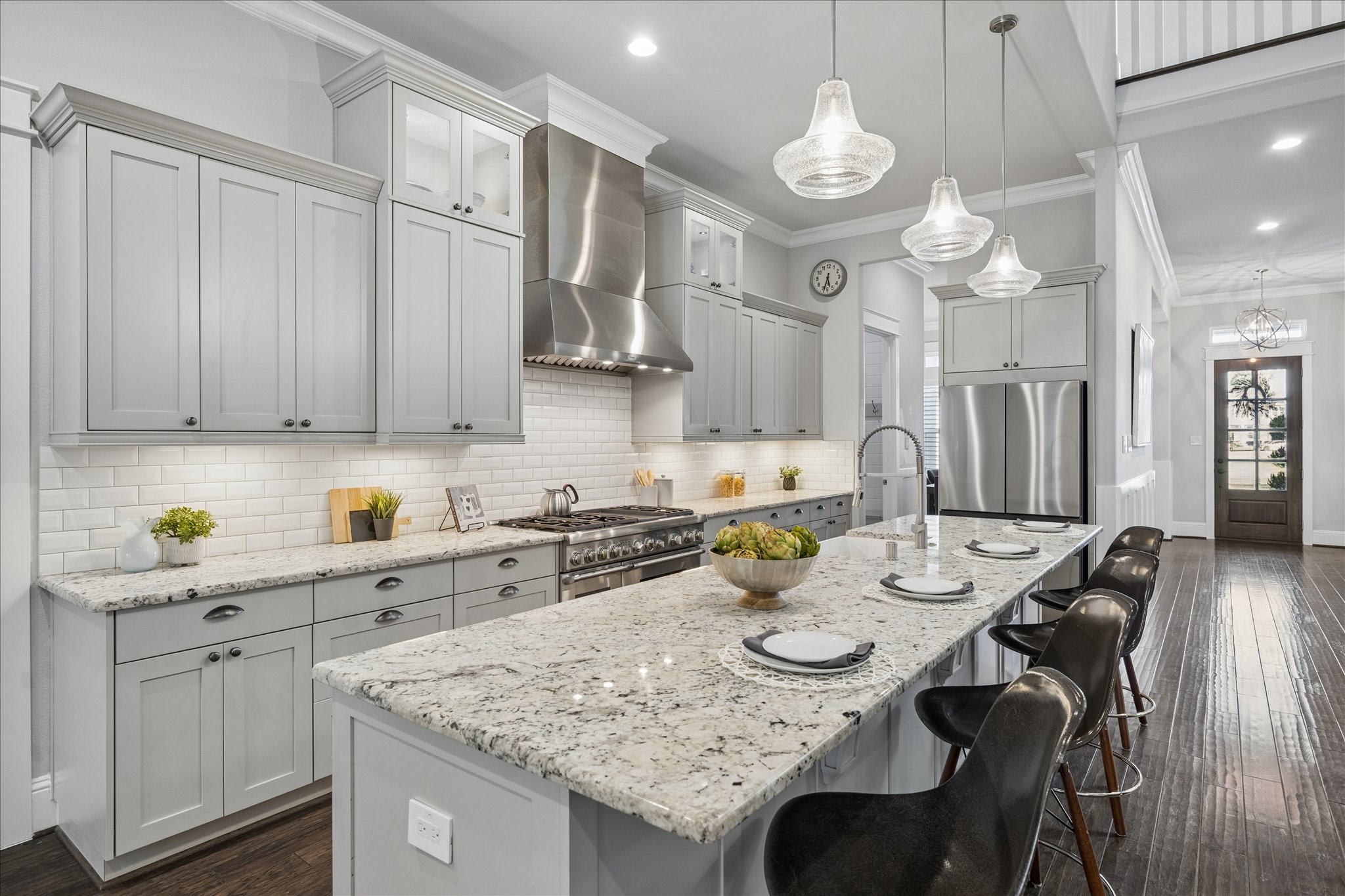 2223 Blue Duck Lane Conroe, TX 77384 - Photo 7 of 38 a kitchen with stainless steel appliances granite countertop a sink a stove a dining table and chairs with wooden floor