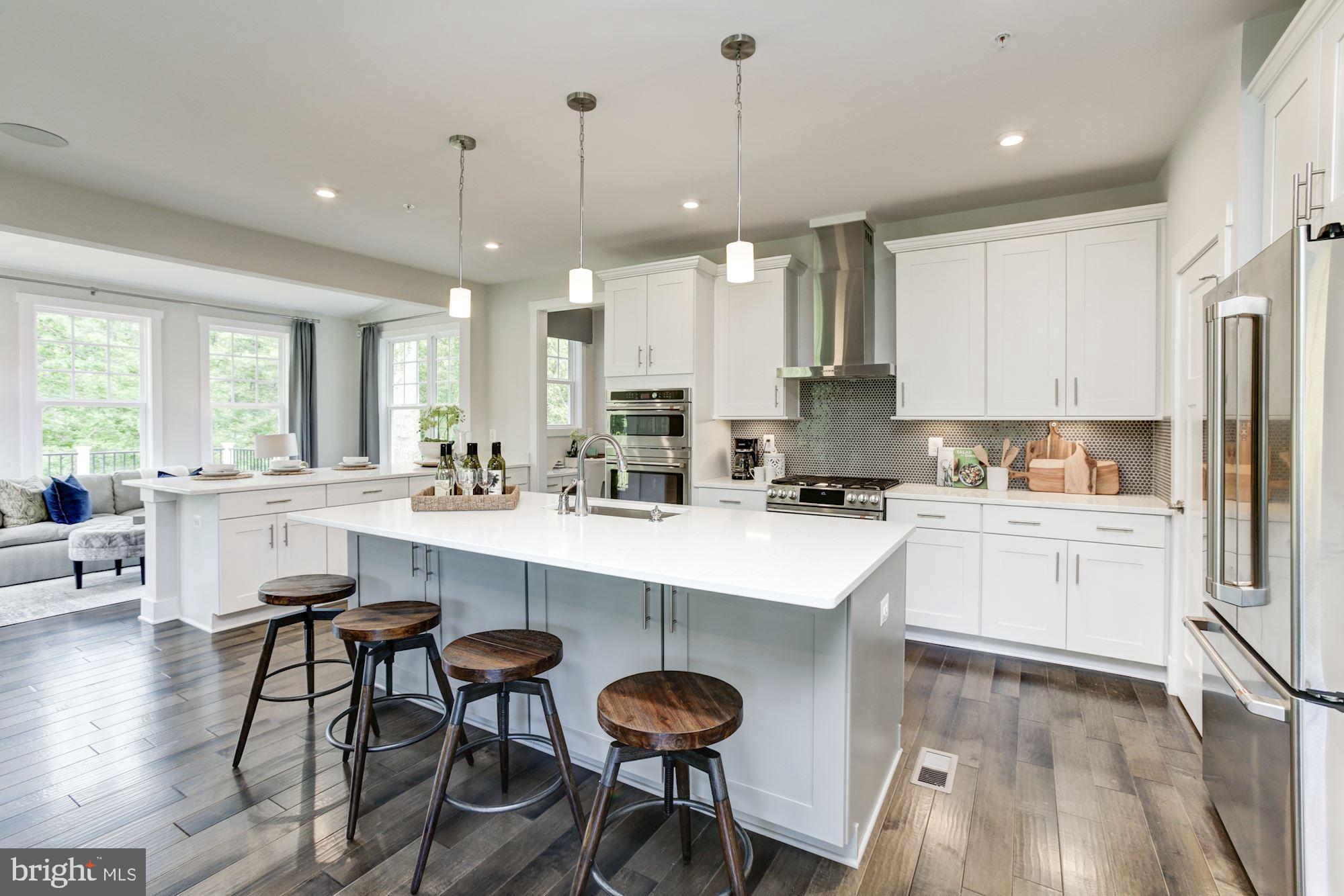 3 Copperleaf Boulevard Hanover, MD 21076 - Photo 14 of 45 a kitchen with stainless steel appliances granite countertop white cabinets a sink a stove a dining table and chairs