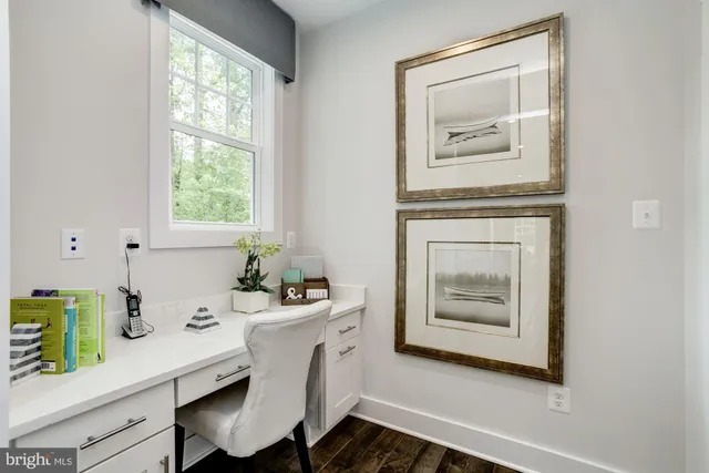 a room with a table and a painting on the wall