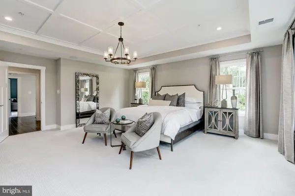 a bedroom with a bed furniture and a chandelier