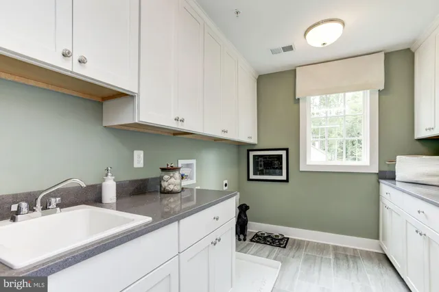 a kitchen with sink cabinets and window