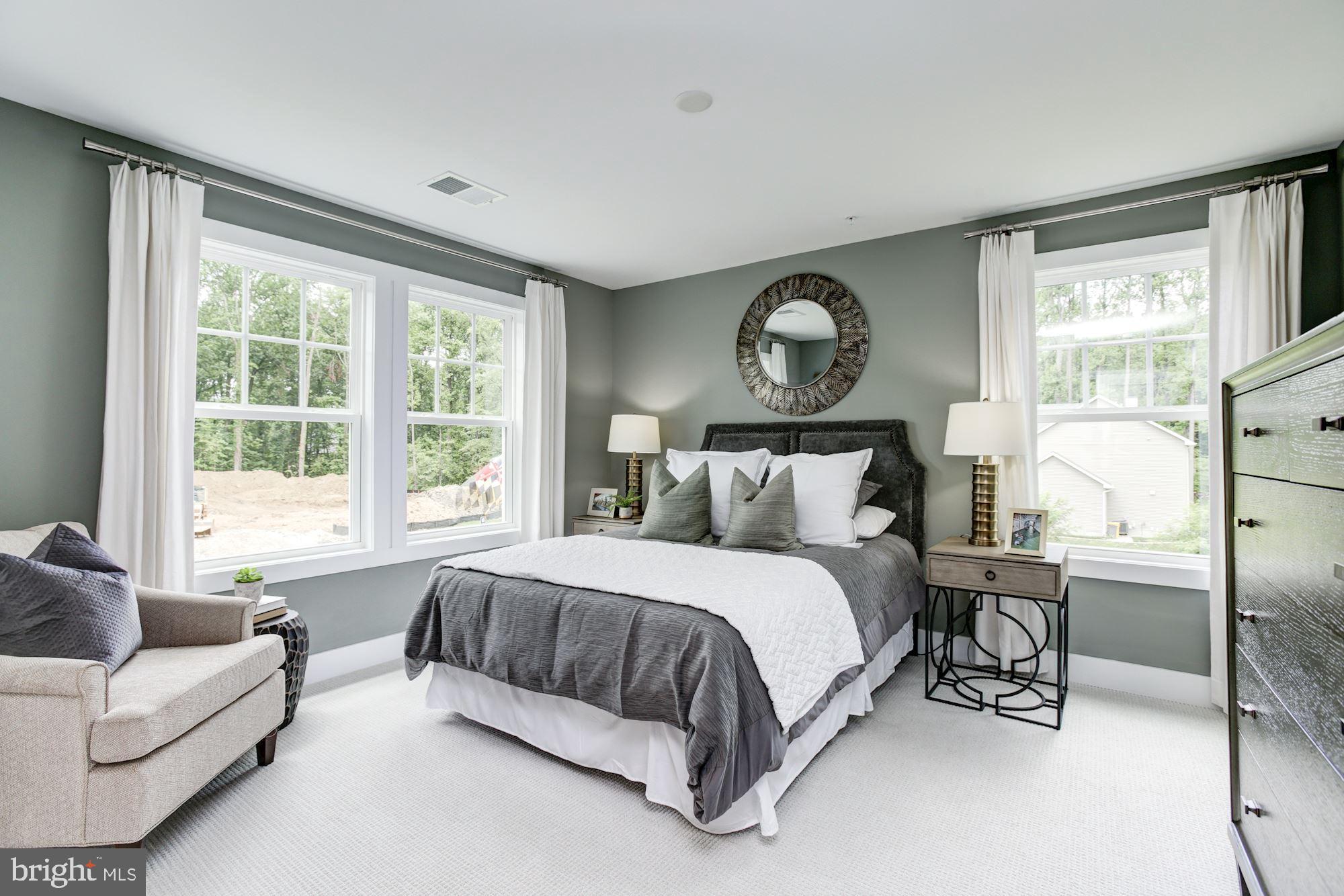 3 Copperleaf Boulevard Hanover, MD 21076 - Photo 29 of 45 a bedroom with a bed a couch and a large window