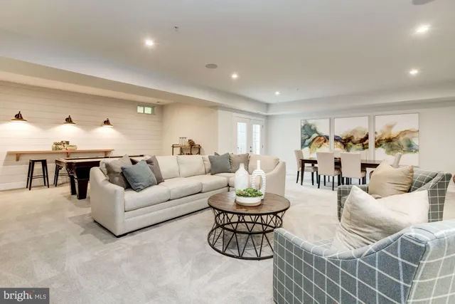 a living room with furniture kitchen view and a table