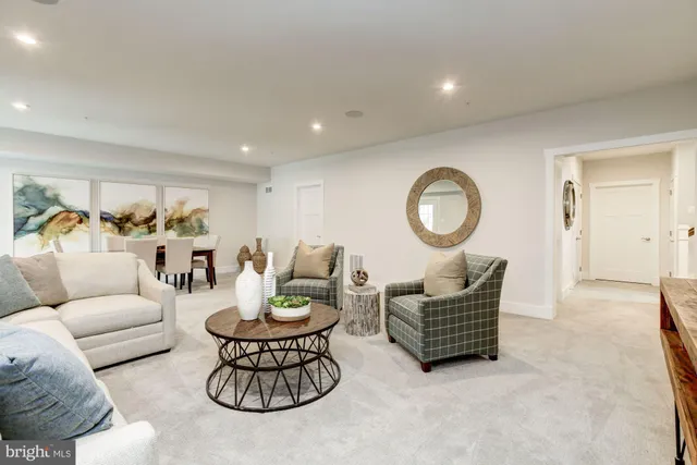 a living room with furniture a mirror and a lamp