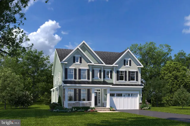 a front view of a house with a garden and plants