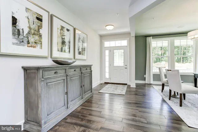 a view of a a kitchen with furniture window and wooden floor