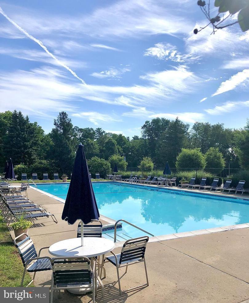 61 Ramsgate Court Blue Bell, PA 19422 - Photo 18 of 20 a view of a lake with a table and chairs