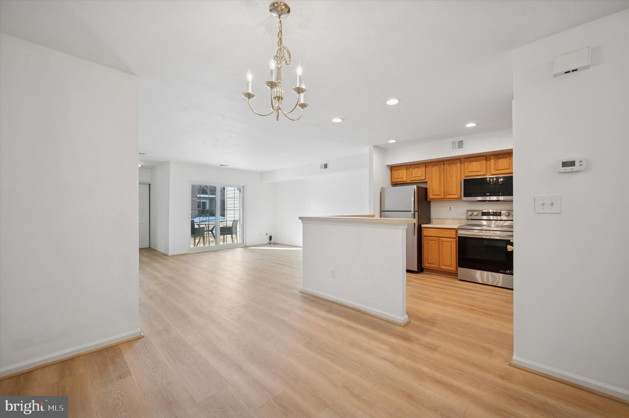 61 Ramsgate Court Blue Bell, PA 19422 - Photo 8 of 20 a view of a kitchen with a sink wooden floor and a large window