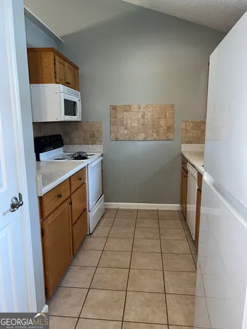 a kitchen with a cabinets and a stove top oven