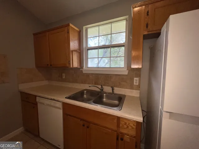 a kitchen with a sink stove and refrigerator