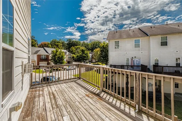 a view of balcony with wooden floor and fence