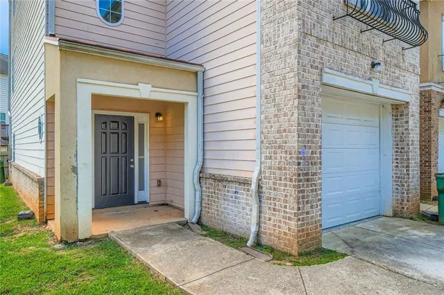 a view of yellow house with a large door