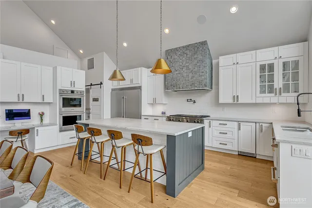 a kitchen with stainless steel appliances a sink a stove and a window