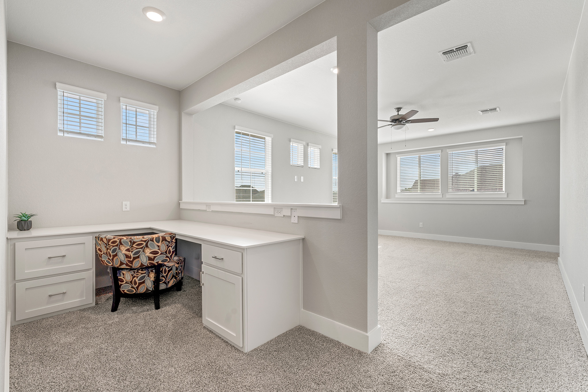 2112 Tobiano Trace Georgetown, TX 78633 - Photo 30 of 40 Unfurnished office featuring built in desk, light colored carpet, healthy amount of natural light, a ceiling fan, and recessed lighting