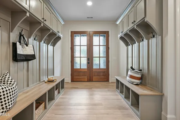 a view of an entryway with wooden floor and a rug