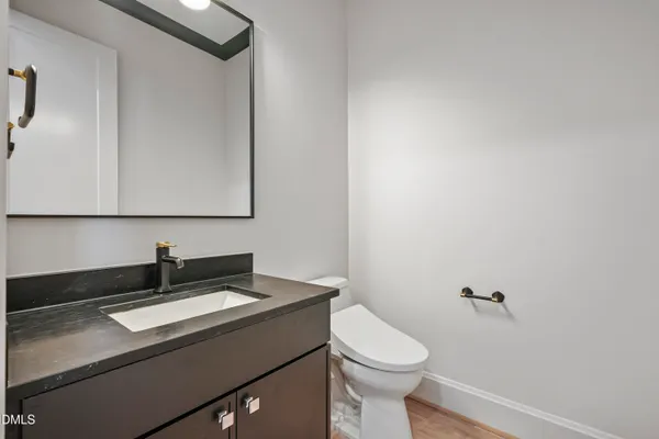 a kitchen with kitchen island a sink stainless steel appliances and white cabinets