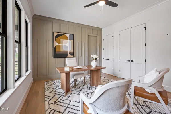 a view of a room with wooden floor and windows