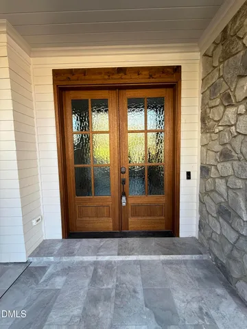 a view of a hallway with wooden floor and stairs