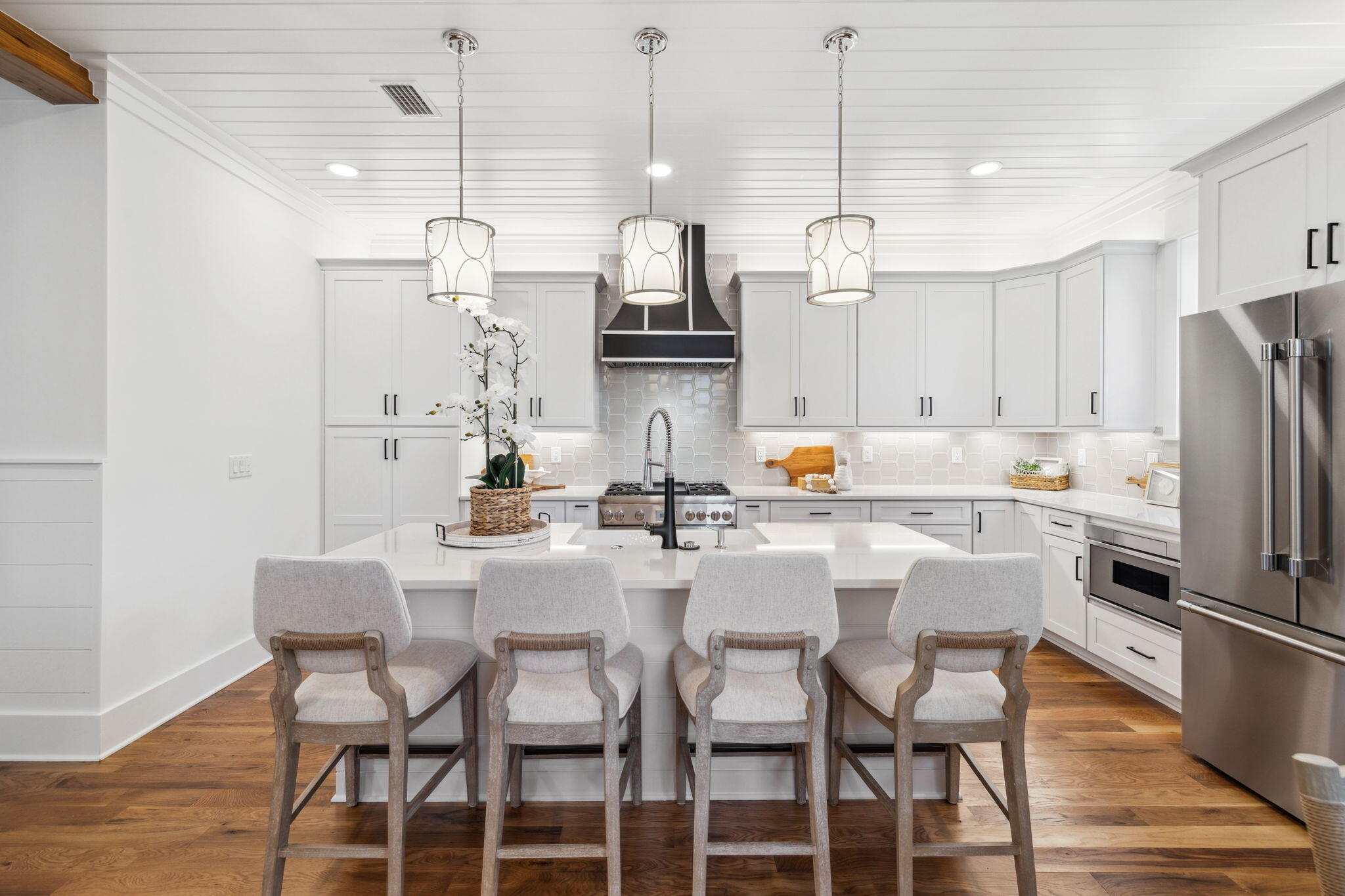 200 Grayton Boulevard Santa Rosa Beach, FL 32459 - Photo 18 of 50 a kitchen with stainless steel appliances kitchen island granite countertop a dining table chairs and white cabinets