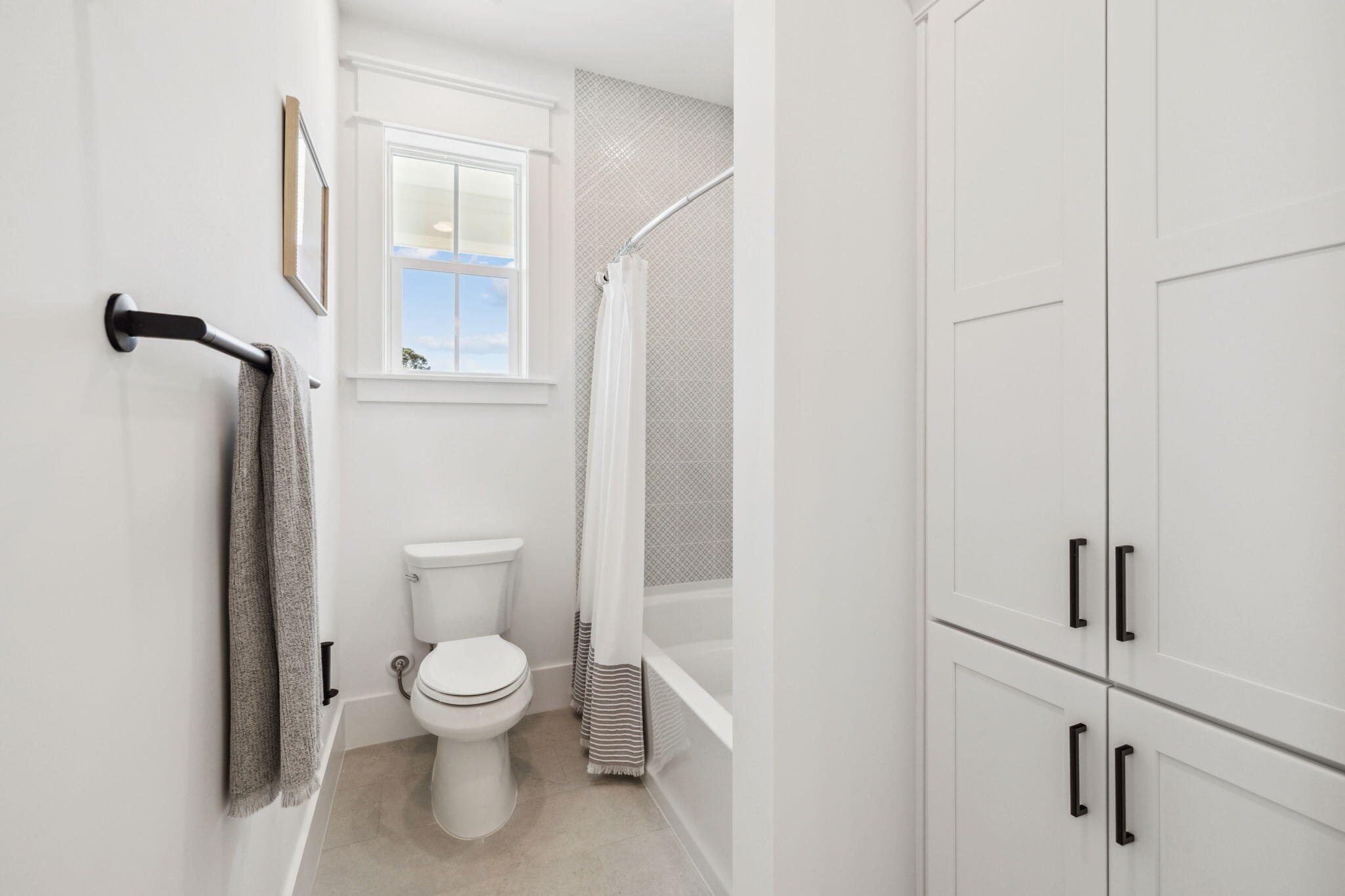 200 Grayton Boulevard Santa Rosa Beach, FL 32459 - Photo 37 of 50 a white toilet sitting next to a bathroom sink