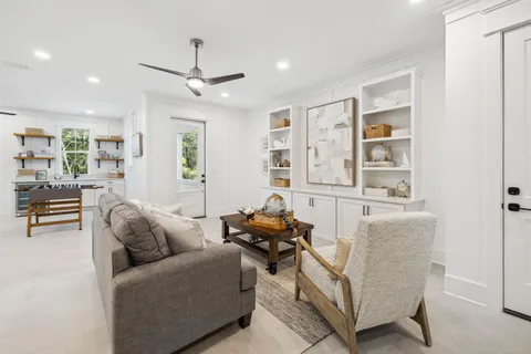 a living room with furniture and kitchen view