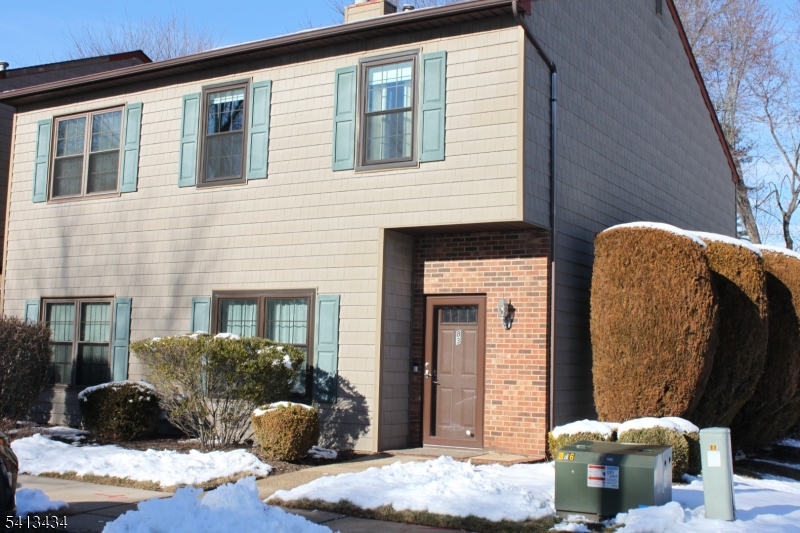 a front view of a house with outdoor seating
