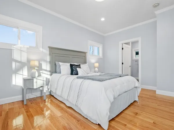 a bedroom with a bed and a night stand