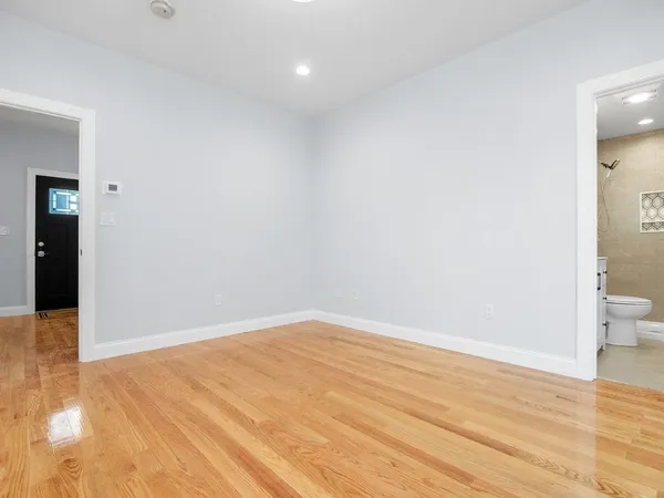 a view of an empty room and wooden floor