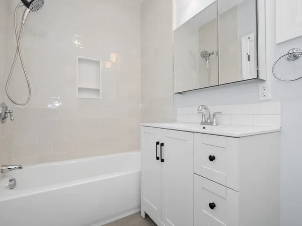 a bathroom with a sink a vanity and bathtub