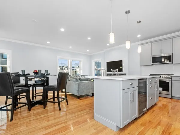 a view of kitchen with cabinets table and chairs